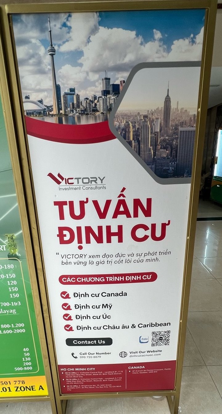 Victory Investment Consultants office standee: immigration consulting programs, Ho Chi Minh City